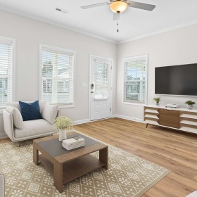 Living room with a couch coffee table and tv at The Cottages at Oak Grove Dairy in Huntsville, AL 