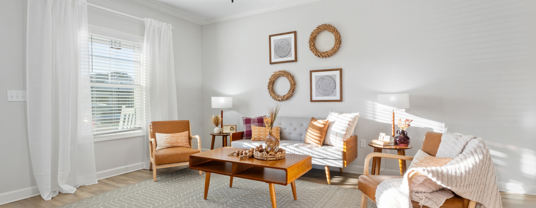 living room with large window at Cottages at Oak Grove Dairy Apartments in Huntsville, AL