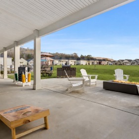corn hole and a firepit with Adirondack chairs
