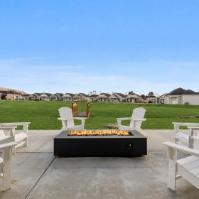 a firepit with Adirondack chairs